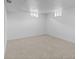 Finished basement with neutral carpet, bright lighting, and freshly painted white walls at 2542 S Winona Ct, Denver, CO 80219