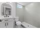 Modern bathroom with neutral toned tile, sleek fixtures, and a glass enclosed shower at 2542 S Winona Ct, Denver, CO 80219