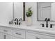 A stylish bathroom boasts a dual sink vanity with contemporary fixtures and decor at 2542 S Winona Ct, Denver, CO 80219