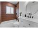 Updated bathroom with tiled shower, white vanity, and modern fixtures at 2542 S Winona Ct, Denver, CO 80219