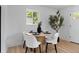 Dining area featuring round table, modern decor, and view to the front entry at 2542 S Winona Ct, Denver, CO 80219