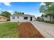 A well-manicured front yard and white painted brick home create great curb appeal at 2542 S Winona Ct, Denver, CO 80219