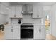 Updated kitchen with white cabinetry, quartz countertops, stainless steel appliances, and stylish hardware at 2542 S Winona Ct, Denver, CO 80219