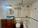 Cozy bathroom features a round mirror, decorative tile accents, and a classic vanity sink at 12470 E Cornell Ave # 203, Aurora, CO 80014