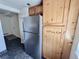 Kitchen with stainless steel refrigerator and wood cabinetry providing ample storage at 12470 E Cornell Ave # 203, Aurora, CO 80014