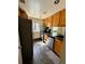 Compact kitchen featuring modern appliances and ample cabinet space for efficient meal preparation at 12470 E Cornell Ave # 203, Aurora, CO 80014