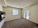 Bright living room with a sliding glass door leading to a balcony offering outdoor space and natural light at 12470 E Cornell Ave # 203, Aurora, CO 80014