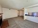Spacious living area showcasing an open layout with fireplace and a view into the kitchen area at 12470 E Cornell Ave # 203, Aurora, CO 80014
