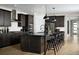 Modern kitchen features sleek dark cabinets, stainless steel appliances, and a central island with breakfast bar seating at 39575 Gwinett Cir, Elizabeth, CO 80107