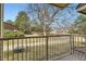 View of the backyard from the balcony highlighting green space, mature trees, and a fenced perimeter at 15491 E Wyoming Dr # E, Aurora, CO 80017