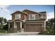 Charming two-story home with a covered porch, two-car garage, and meticulously landscaped front yard at 164 Baler Ct, Brighton, CO 80601