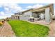 Landscaped backyard with a green lawn, a covered patio, and beautiful curb appeal at 19409 W 88Th Dr, Arvada, CO 80007