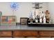 Close up of bar with sports memorabilia, liquor display, and gray countertops at 19409 W 88Th Dr, Arvada, CO 80007