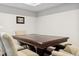 Basement dining area with a dark wood table and six upholstered chairs, enhanced by overhead lighting at 19409 W 88Th Dr, Arvada, CO 80007
