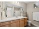 Bathroom featuring a white countertop vanity, a large mirror, and tile flooring at 19409 W 88Th Dr, Arvada, CO 80007