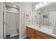 Bright bathroom with a single sink vanity and a shower with a white curtain at 19409 W 88Th Dr, Arvada, CO 80007
