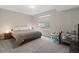 Cozy bedroom with a queen-sized bed, soft carpet, and bright natural light at 19409 W 88Th Dr, Arvada, CO 80007