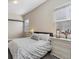 Bedroom with light gray walls, soft carpet, and lots of natural light at 19409 W 88Th Dr, Arvada, CO 80007
