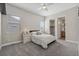 Comfortable bedroom featuring a ceiling fan, natural light, and an attached bathroom at 19409 W 88Th Dr, Arvada, CO 80007