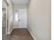 Welcoming entryway featuring hardwood floors, neutral walls, and a bright white door at 19409 W 88Th Dr, Arvada, CO 80007
