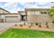 Inviting single-Gathering home featuring a stone facade, manicured lawn, and an attached two-car garage at 19409 W 88Th Dr, Arvada, CO 80007