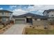Charming single Gathering home with an attached two car garage and a well maintained front yard at 19409 W 88Th Dr, Arvada, CO 80007