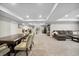 Open finished basement featuring a dining area, living room and bar with a modern design at 19409 W 88Th Dr, Arvada, CO 80007
