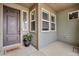 Cozy covered front porch with a stylish door, charming accents, and a welcoming atmosphere at 19409 W 88Th Dr, Arvada, CO 80007