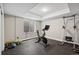 Brightly lit home gym featuring exercise equipment and neutral walls at 19409 W 88Th Dr, Arvada, CO 80007