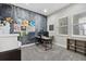 Bright office space with a decorative accent wall, natural light, and gray carpeting at 19409 W 88Th Dr, Arvada, CO 80007