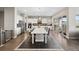 Bright, open kitchen features white cabinets, stainless steel appliances and a spacious island with seating at 19409 W 88Th Dr, Arvada, CO 80007