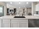 Open kitchen with island, sink, white cabinets, and stainless-steel dishwasher at 19409 W 88Th Dr, Arvada, CO 80007
