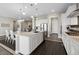 Kitchen with island, seating, stainless steel appliances, and tile backsplash at 19409 W 88Th Dr, Arvada, CO 80007