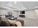 Finished basement living area featuring recessed lights, plush carpeting and a large sectional sofa at 19409 W 88Th Dr, Arvada, CO 80007