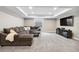 Finished basement living area featuring recessed lights, plush carpeting and a large sectional sofa at 19409 W 88Th Dr, Arvada, CO 80007