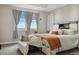 Bright primary bedroom features a trey ceiling, plush carpet, and large windows at 19409 W 88Th Dr, Arvada, CO 80007