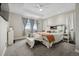 Bright primary bedroom features a trey ceiling, plush carpet, and large windows at 19409 W 88Th Dr, Arvada, CO 80007