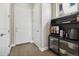 A mud room with wood floor features a coffee bar and storage, conveniently located near the entrance at 19409 W 88Th Dr, Arvada, CO 80007