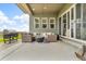Covered patio with comfortable seating area, grill, and sliding glass doors leading inside at 19409 W 88Th Dr, Arvada, CO 80007