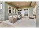 Covered patio area with a cozy seating arrangement and an outdoor fire pit at 19409 W 88Th Dr, Arvada, CO 80007