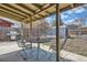 Outdoor patio featuring a table, chairs, grill, above-ground pool, and shed at 1255 S Hoyt St, Lakewood, CO 80232