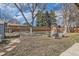 Large backyard with a garden, patio furniture, and a wooden fence at 1255 S Hoyt St, Lakewood, CO 80232