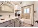 Well-lit bathroom with a vanity, framed mirror, a combination bathtub and shower, and modern fixtures at 1255 S Hoyt St, Lakewood, CO 80232