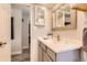 Modern bathroom featuring neutral gray tones, a vanity with gray cabinets, and an open doorway to adjacent space at 1255 S Hoyt St, Lakewood, CO 80232