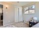 Comfortable bedroom with a closet, neutral-toned walls, plush carpet, and natural light from the window at 1255 S Hoyt St, Lakewood, CO 80232