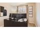 Functional home office with a large desk, multiple monitors, and a window for natural light creating an ideal workspace at 1255 S Hoyt St, Lakewood, CO 80232