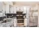 Modern kitchen with stainless steel appliances, granite countertops, and a stylish backsplash at 1255 S Hoyt St, Lakewood, CO 80232