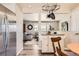 Bright kitchen with stainless steel refrigerator and view into the cozy living room at 1255 S Hoyt St, Lakewood, CO 80232