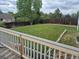 Scenic view from the deck, showcasing a large backyard with mature trees and a wooden fence for privacy at 1415 S Pitkin Ct, Aurora, CO 80017