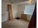 Unfinished basement with window, neutral carpet, and a rectangular cut-out in the floor at 1415 S Pitkin Ct, Aurora, CO 80017